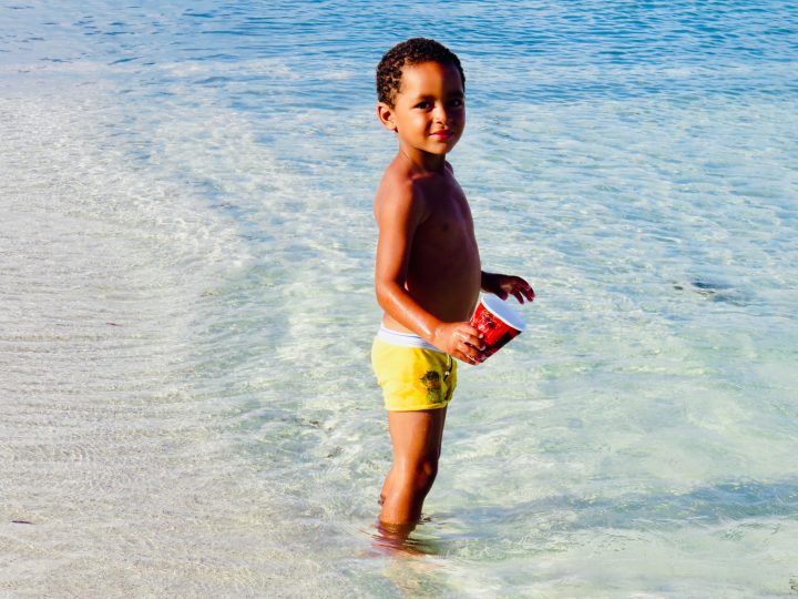 Local kid playing at the beach in Belize, Belize Travel Blog