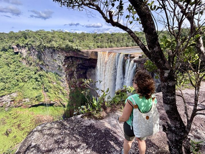 Mirja holding a tree near the open viewpoints at Kaieteur Falls Guyana