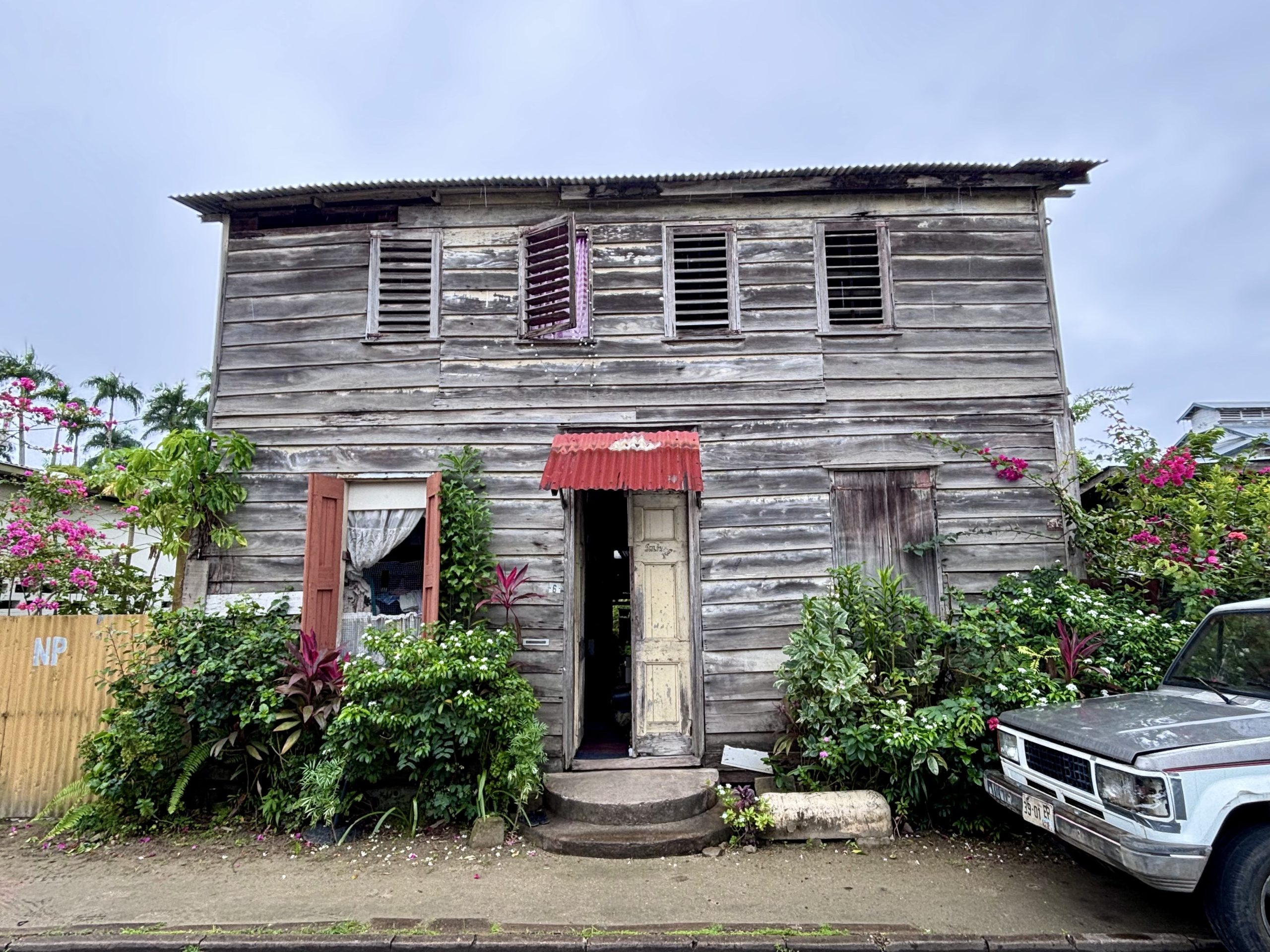 Street view in Paramaribo with wooden houses and daily life in Suriname’s capital