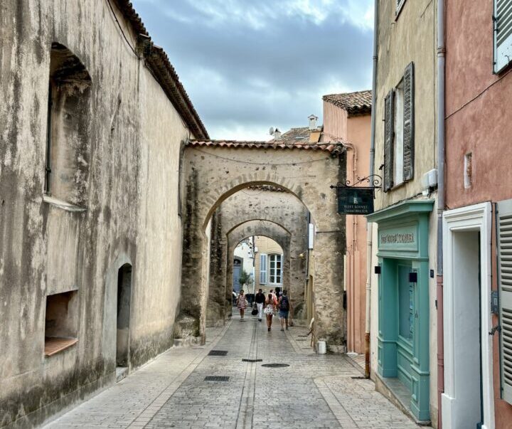 Narrow stone street and archway in La Ponche Old Town, Saint-Tropez