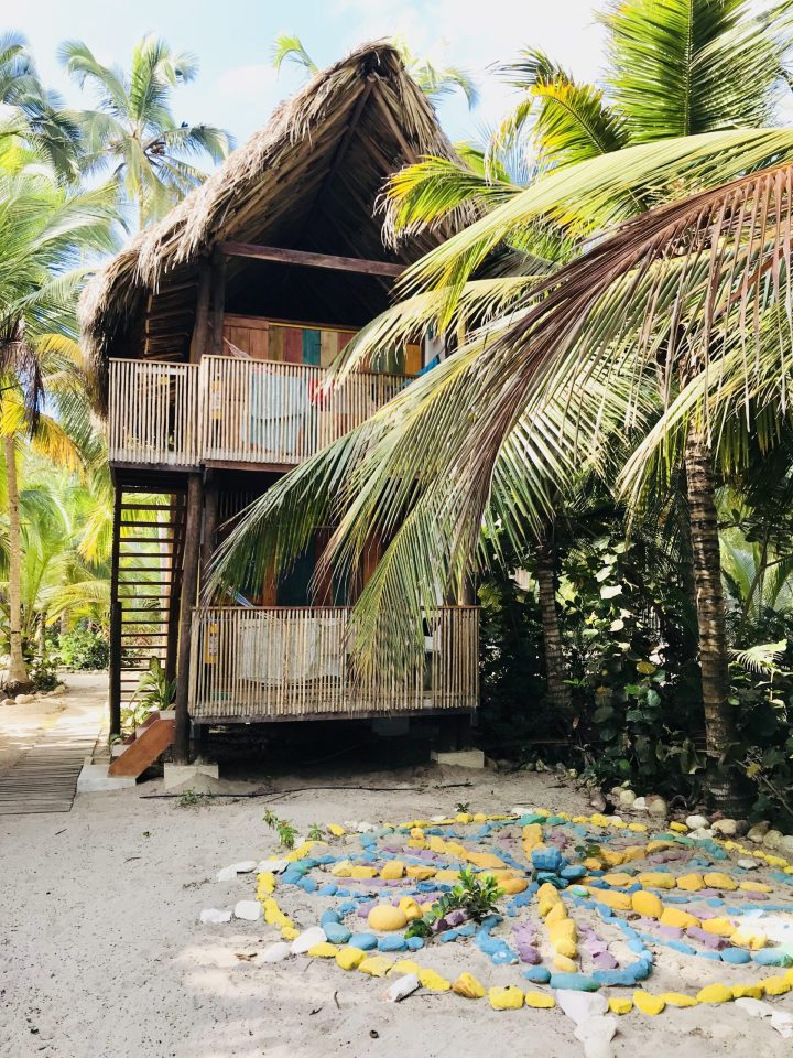 Private bungalow surrounded by palm trees at Costeño Beach Colombia
