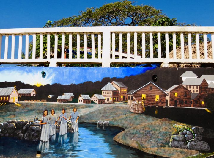 Colorful mural in San Ignacio Belize showing local life and the Macal River