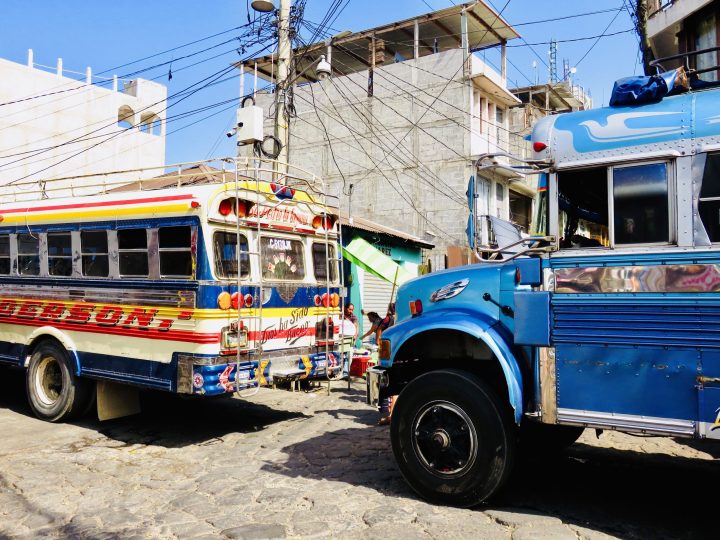 Cars and colorful buses in San Pedro La Laguna, Guatemala