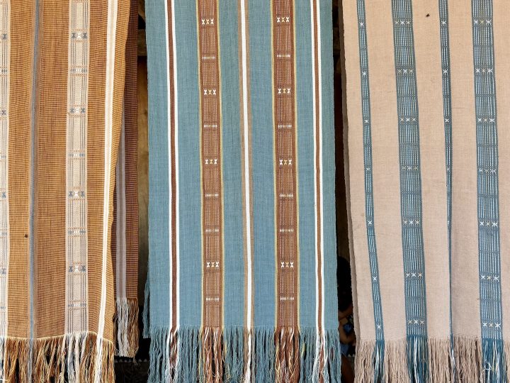 Colorful woven ikat cloths for sale in Bena Village