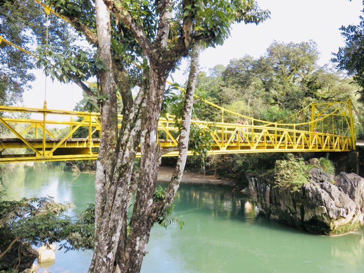 Yellow bridge over the river at Semuc Champey Guatemala